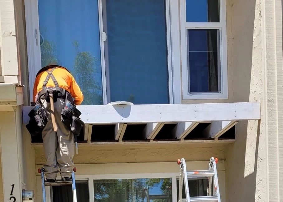 Commercial balcony structure mid-replacement showing new framing