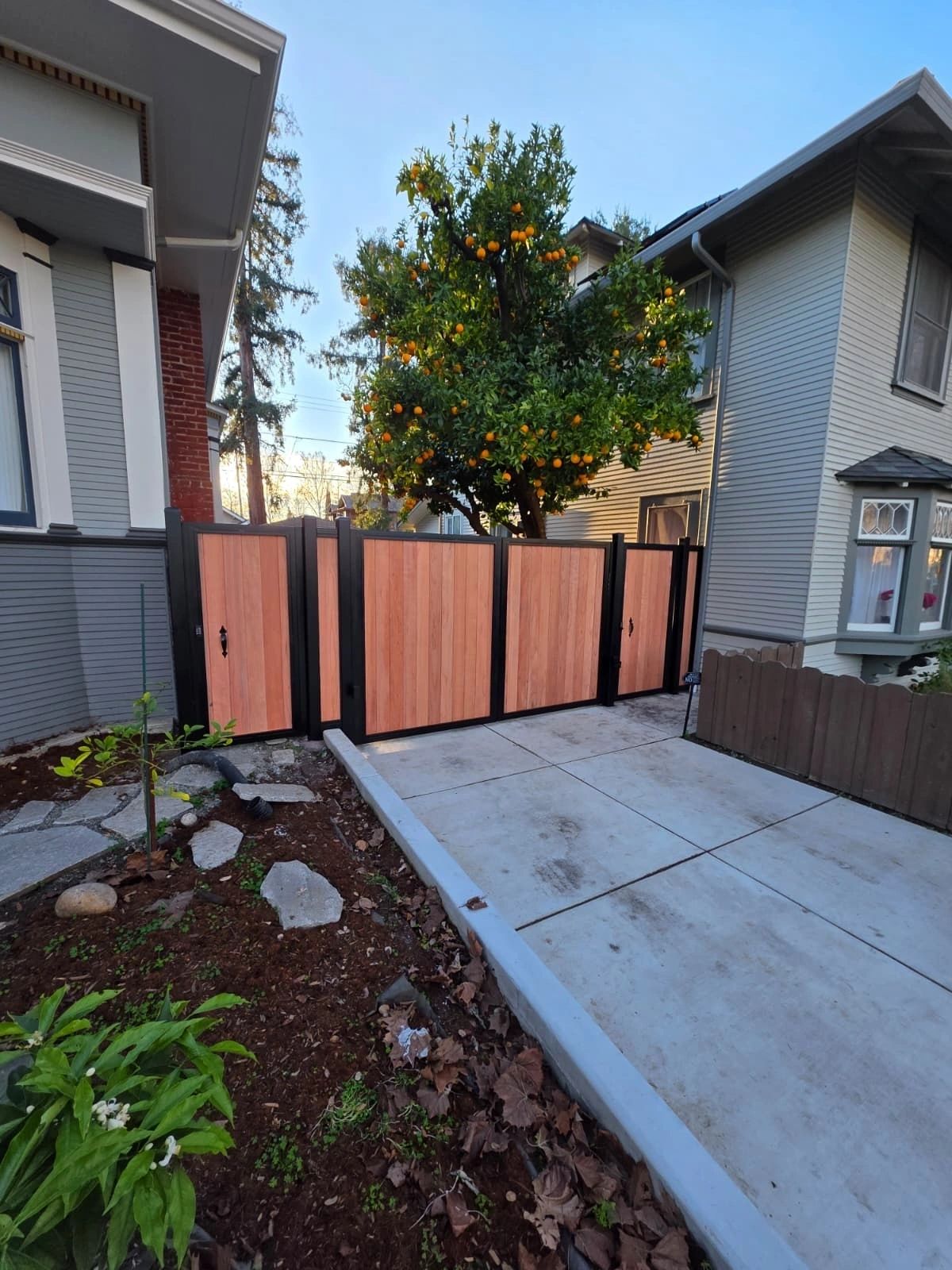 Featured custom double gate project with matching wood fence