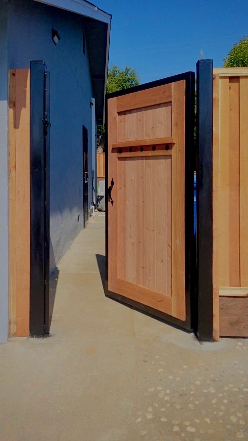 Wood gate built on a black metal frame for added durability