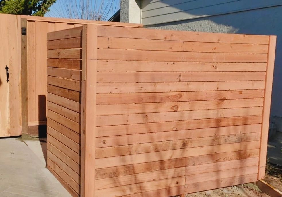 Custom wood enclosure built to screen trash cans from view