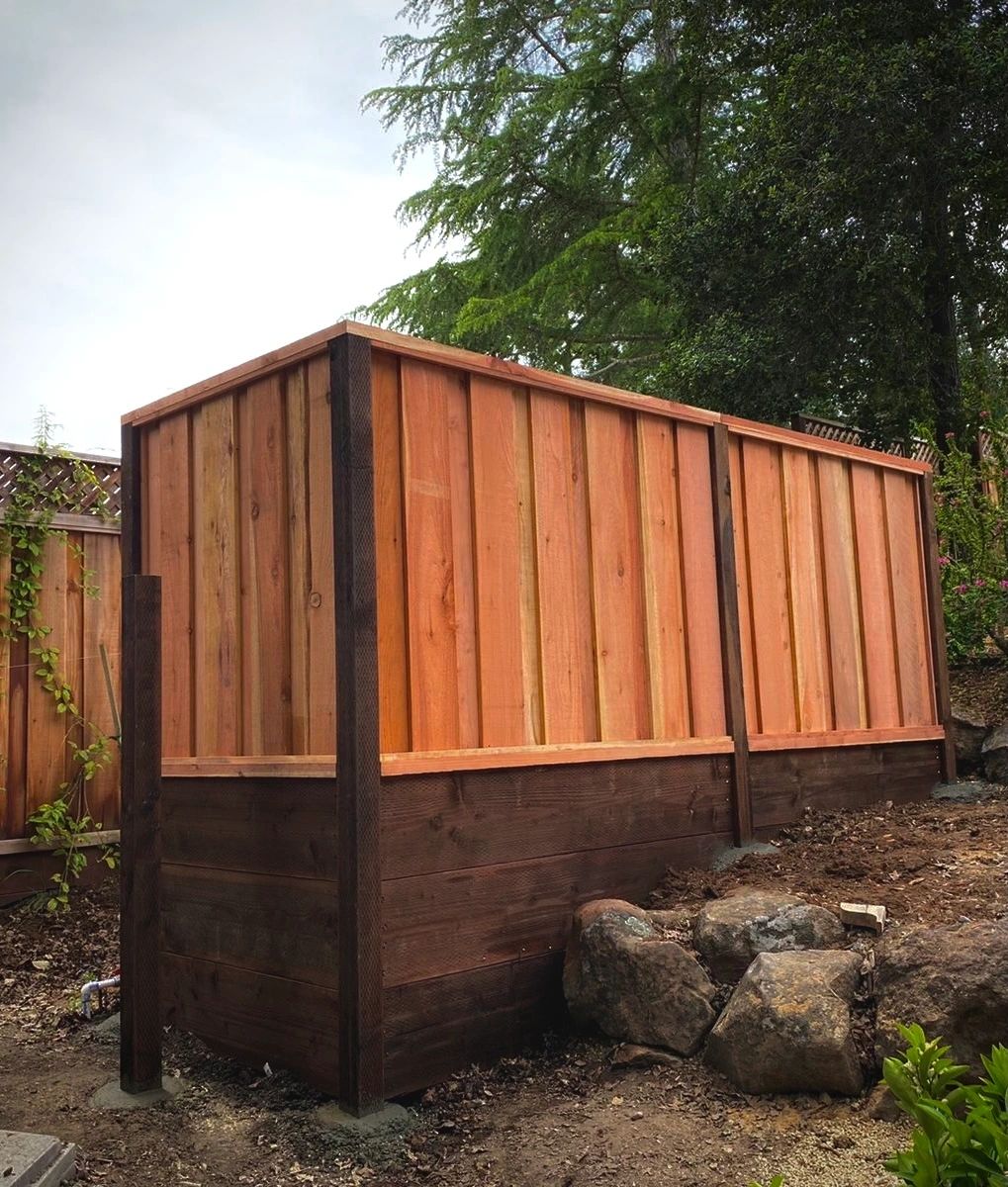 Completed wood fence enclosure hiding pool equipment