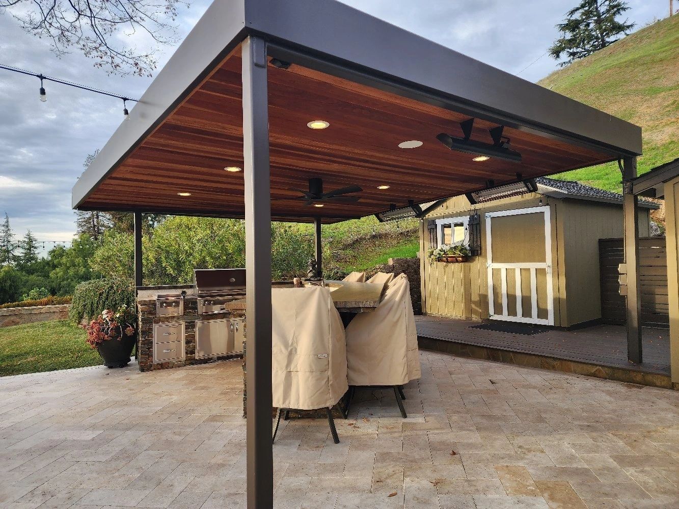 Wooden patio cover over outdoor kitchen and dining area